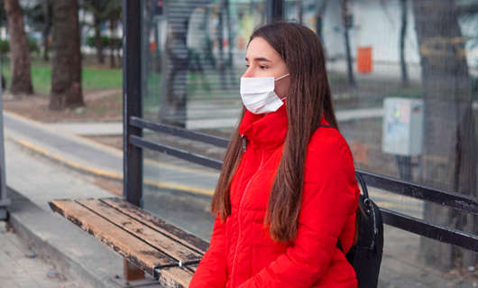 1690784660129822.jpg woman-wearing-surgical-mask-bus-stop.jpg